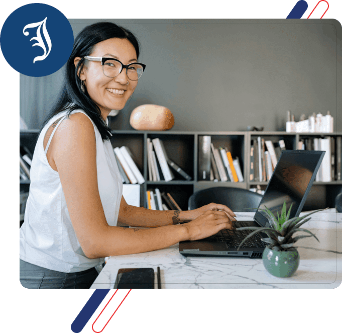 A woman sitting at a table with a laptop.